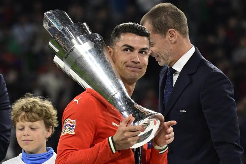 Portugal's forward #07 Cristiano Ronaldo carries the trophy after winning the UEFA Nations League final football match between Portugal and Spain in Munich, southern Germany on June 8, 2025.  John MACDOUGALL / AFP