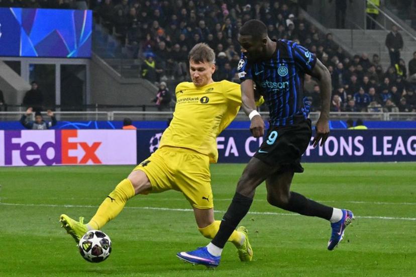 Inter Milan's French forward #09 Marcus Thuram (R) shoots past Bodo/Glimt's Norwegian defender #04 Odin Bjortuft during the UEFA Champions League second-leg play-off football match between Inter Milan and Bodo/Glimt at San Siro stadium in Milan, northern Italy, on February 24, 2026.   Andreas SOLARO / AFP