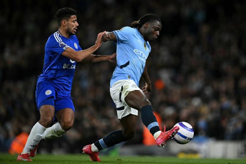 Leicester City's English defender #02 James Justin battles for the ball with Manchester City's Belgian midfielder #11 Jeremy Doku during the English Premier League football match between Manchester City and Leicester City at the Etihad Stadium in Manchester, north west England, on April 2, 2025.  Oli SCARFF / AFP