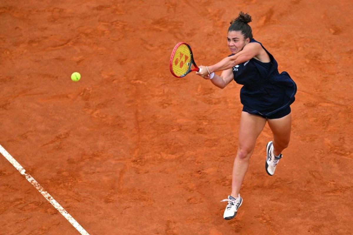 Italy's Jasmine Paolini plays a backhand return to USA's Coco Gauff during their women's singles final match for the WTA Rome Open tennis tournament at Foro Italico in Rome on May 17, 2025.  Andreas SOLARO / AFP