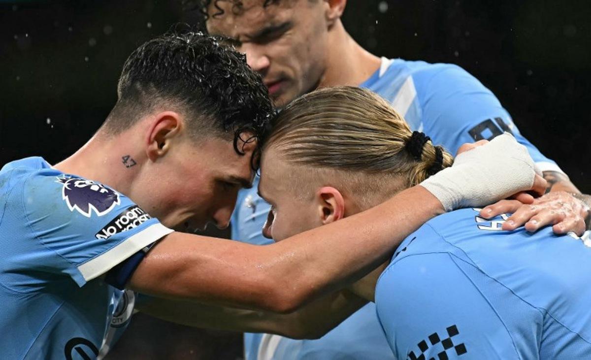 Manchester City's Norwegian striker #09 Erling Haaland (R) celebrates scoring the team's third goal with Manchester City's English midfielder #47 Phil Foden and Manchester City's English midfielder #33 Nico O'Reilly during the English Premier League football match between Manchester City and Fulham at the Etihad Stadium in Manchester, north west England, on February 11, 2026.  Paul ELLIS / AFP