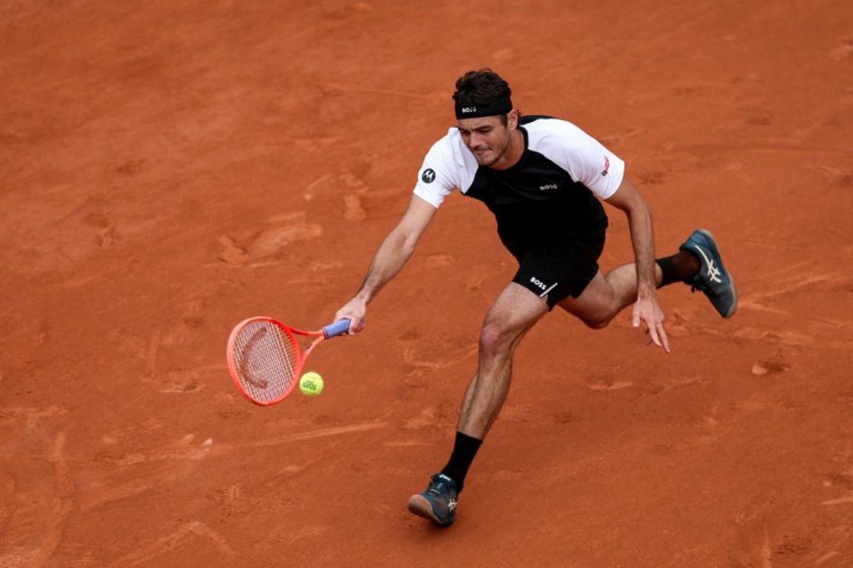 US Taylor Fritz plays a forehand return to Germany's Daniel Altmaier during their men's singles match on day 2 of the French Open tennis tournament on Court Simonne-Mathieu at the Roland-Garros Complex in Paris on May 26, 2025.  Alain JOCARD / AFP