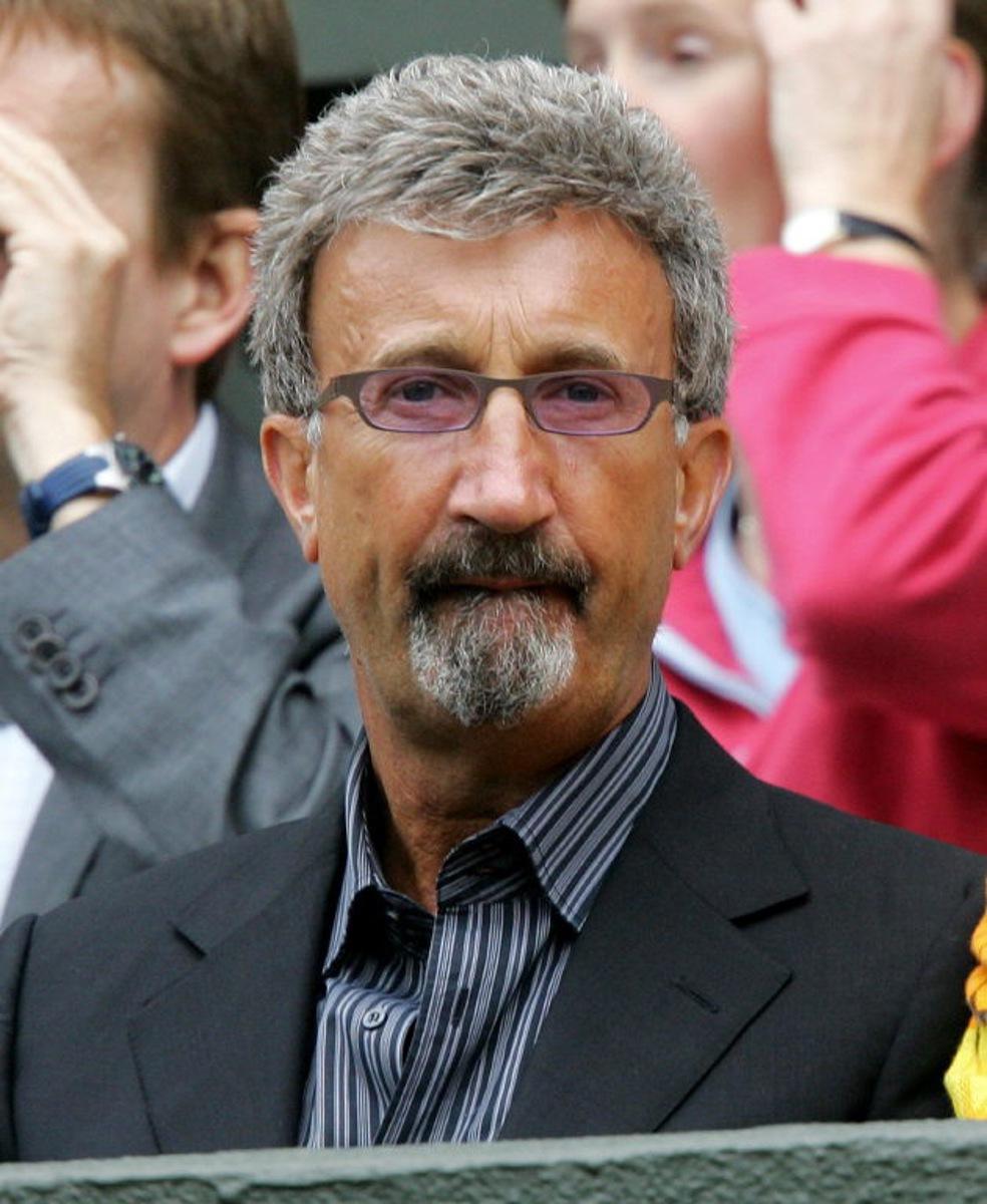Formula 1 team owner Eddie Jordan watches Lleyton Hewitt of Australia play Roger Federer of Switzerland during their quarter-final round match at the 118th Wimbledon Tennis Championships in Wimbledon, London 30 June, 2004.  AFP PHOTO/NICOLAS ASFOURI  Nicolas ASFOURI / AFP