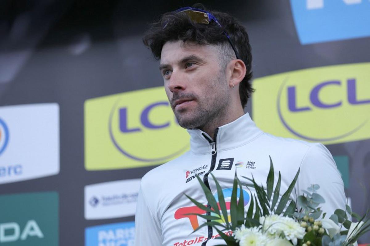 TotalEnergies' French cyclist Pierre Latour celebrates his combativity award on the podium after the 5th stage of the Paris-Nice cycling race, 193,5 km between Saint-Sauveur-de-Montagut and Sisteron, on March 7, 2024.  Thomas SAMSON / AFP