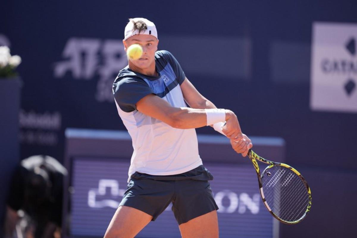Denmark's Holger Rune returns the ball to Spain's Carlos Alcaraz during the ATP Barcelona Open "Conde de Godo" tennis tournament singles final match at the Real Club de Tenis in Barcelona, on April 20, 2025.  MANAURE QUINTERO / AFP