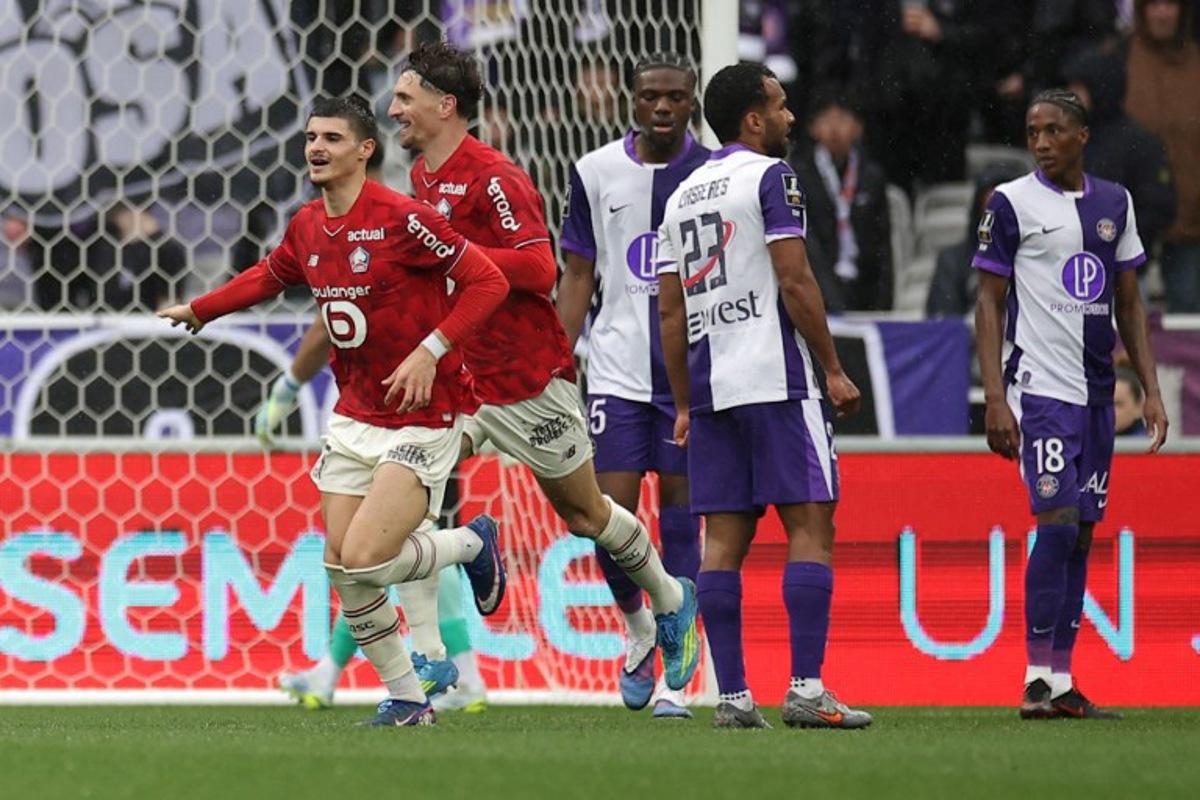Lille's players celebrate after scoring the team first goal during the French L1 football match between Toulouse FC and Lille LOSC at the TFC Stadium in Toulouse, southwestern France, on April 12, 2026.  Valentine CHAPUIS / AFP