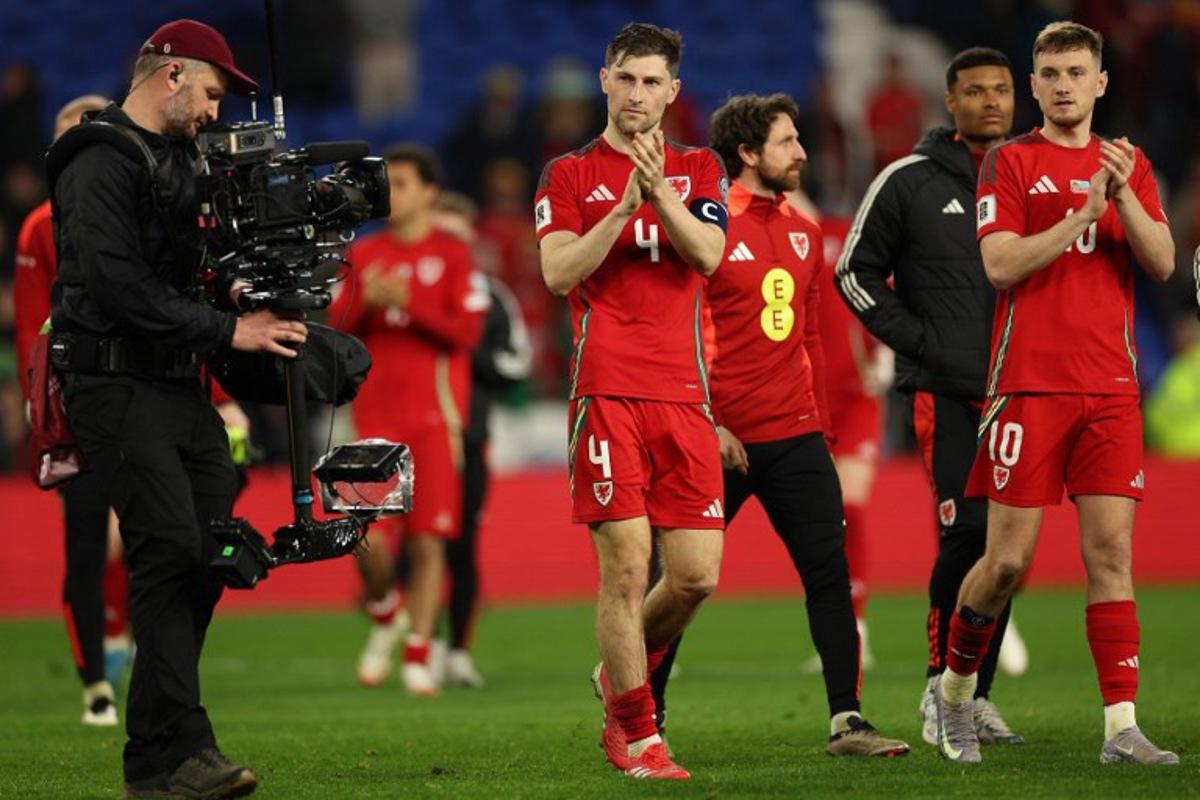 Wales' defender #04 Ben Davies (C) and Wales' midfielder #10 David Brooks (R) applaud the fans following during the 2026 World Cup Group J qualifier football match between Wales and Kazakhstan, at Cardiff City Stadium, in Cardiff, on March 22, 2025.  Wales won the match 3-1. Adrian Dennis / AFP