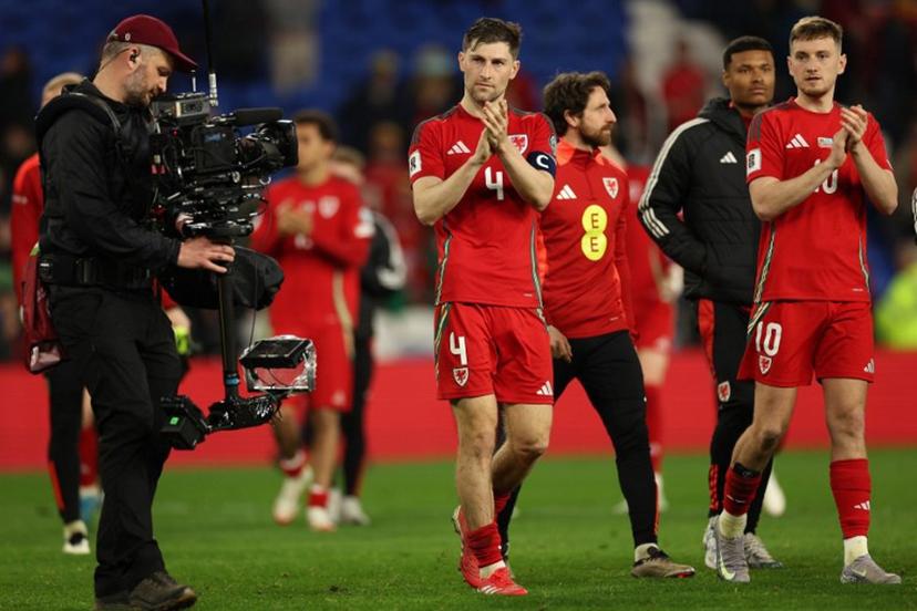 Wales' defender #04 Ben Davies (C) and Wales' midfielder #10 David Brooks (R) applaud the fans following during the 2026 World Cup Group J qualifier football match between Wales and Kazakhstan, at Cardiff City Stadium, in Cardiff, on March 22, 2025.  Wales won the match 3-1. Adrian Dennis / AFP