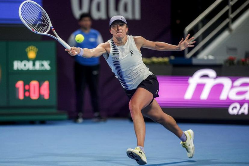 Poland's Iga Swiatek returns a shot during her women's singles quarter-final match against Greece's Maria Sakkari at the Qatar Open tennis tournament in Doha on February 12, 2026.  Karim JAAFAR / AFP