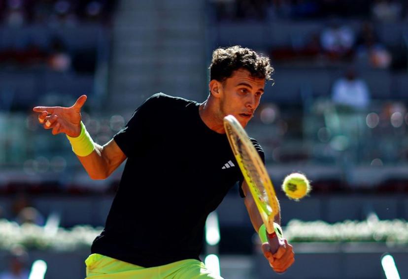 Argentina's Juan Manuel Cerundolo returns the ball to Russia's Daniil Medvedev during their 2025 ATP Tour Madrid Open tennis tournament third round singles match at the Caja Magica in Madrid, on April 27, 2025.  OSCAR DEL POZO / AFP