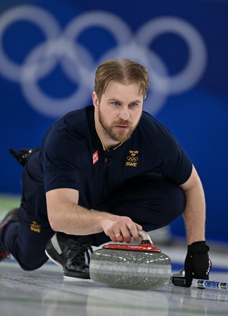 Sweden's Rasmus Wrana competes in the curling mixed doubles round robin gold medal game between Sweden and USA during the Milano Cortina 2026 Winter Olympic Games at the Cortina Curling Olympic Stadium in Cortina d'Ampezzo on February 10, 2026.  François-Xavier MARIT / AFP