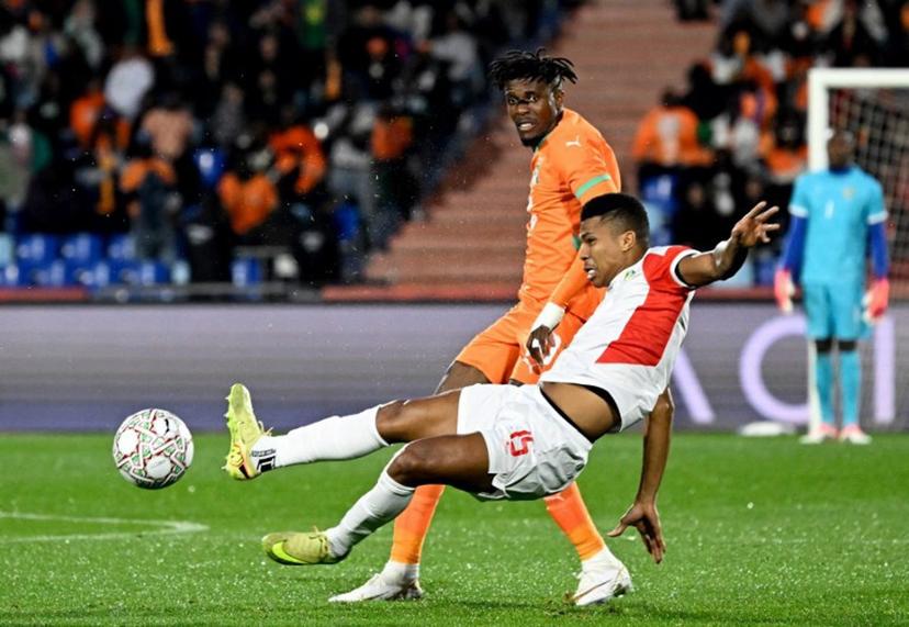 Ivory Coast's forward #10 Wilfried Zaha (L) is tackled by Mozambique's defender #15 Reinildo Mandava during the Africa Cup of Nations (CAN) Group F football match between Ivory Coast and Mozambique at Marrakesh Stadium in Marrakesh on December 24, 2025.   Khaled DESOUKI / AFP