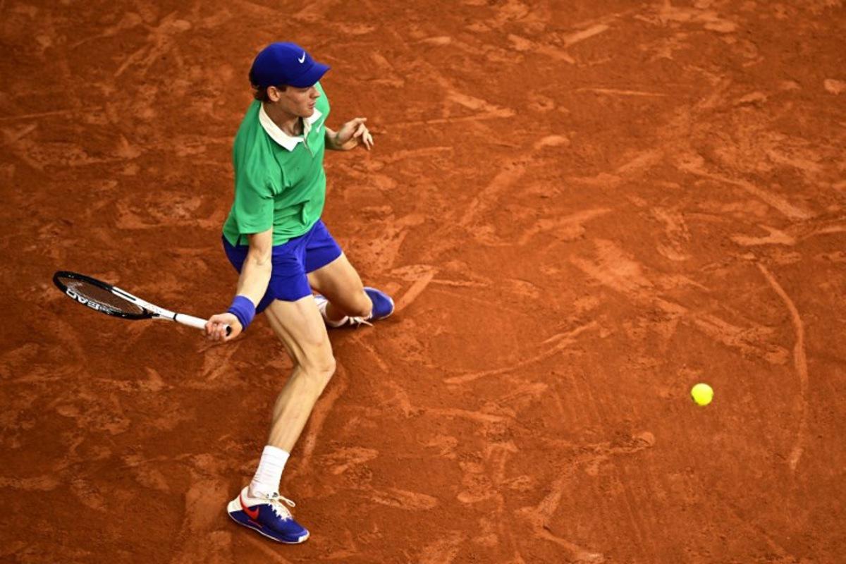 Italy's Jannik Sinner plays a forehand return to Serbia's Novak Djokovic during their men's singles semi-final match on day 13 of the French Open tennis tournament on Court Philippe-Chatrier at the Roland-Garros Complex in Paris on June 6, 2025.  JULIEN DE ROSA / AFP