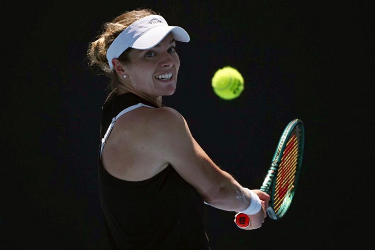 USA's Caty McNally hits a return against Japan's Himeno Sakatsume during their women's singles match on day one of the Australian Open tennis tournament in Melbourne on January 18, 2026.  WILLIAM WEST / AFP