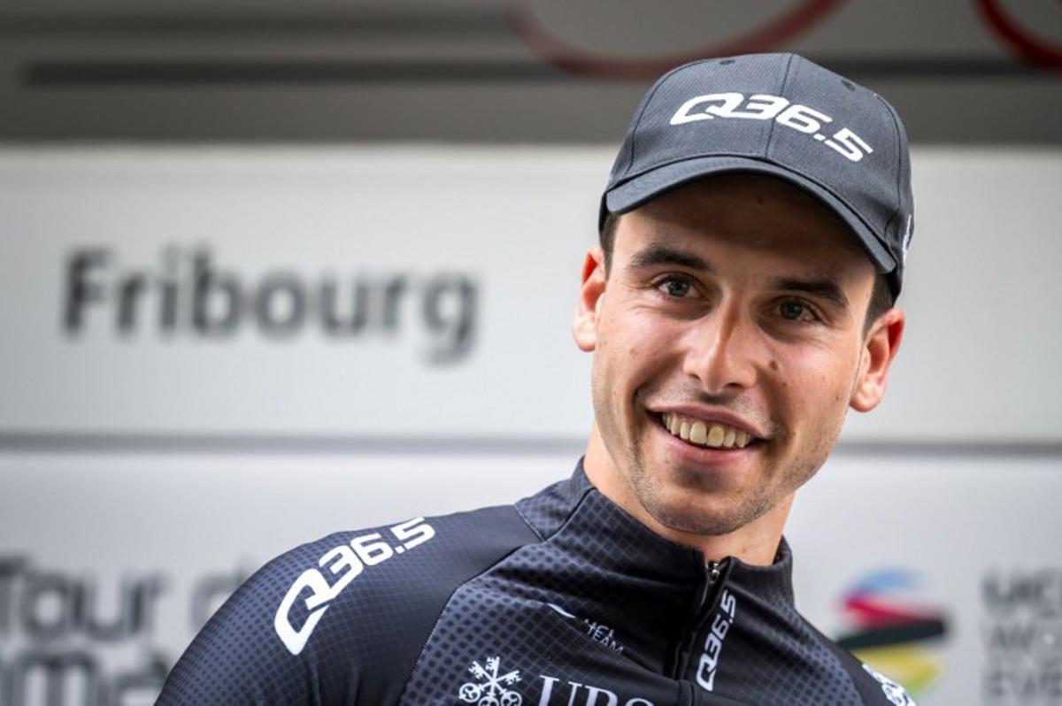 Swiss cyclist Fabio Christen of Q36.5 Pro Cycling team smiles after being awarded best Swiss rider during the podium ceremony of the first stage of the Tour of Romandy UCI cycling World tour 165,7 km from Chateau d'Oex to Fribourg, on April 24, 2024.  Fabrice COFFRINI / AFP