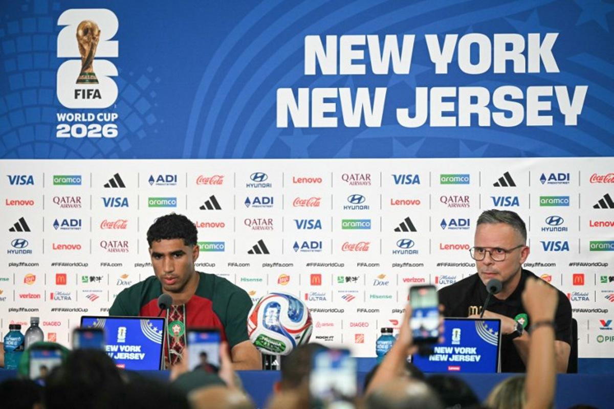 Morocco's head coach Mohamed Ouahbi (R) speaks alongside Morocco's Achraf Hakimi during a press conference at the New York/New Jersey Stadium in East Rutherford on June 12, 2026, on the eve of the 2026 World Cup football match between Brazil and Morocco.  Mauro PIMENTEL / AFP