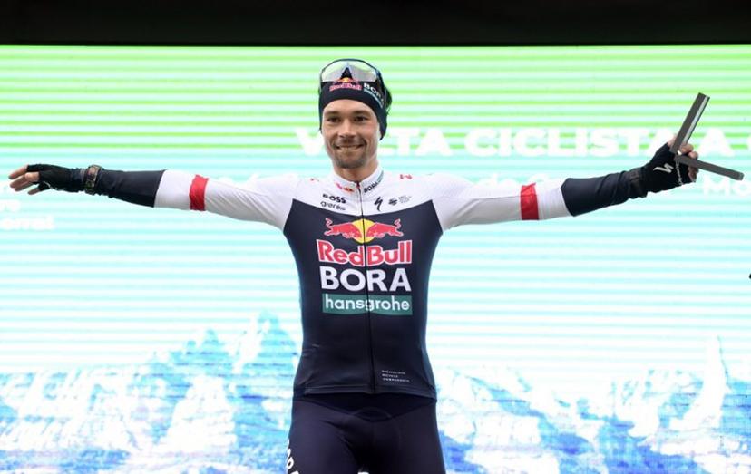 The new overall leader Team Bora's Primoz Roglic celebrates on the podium after winning the 4th stage of the 2025 Volta a Catalunya cycling tour of Catalonia, a 188,7 km race between Sant Vicenc de Castellet and Montserrat, on March 27, 2025.  Josep LAGO / AFP