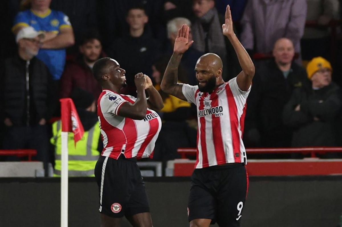 Brentford's Italian defender #33 Michael Kayode (L) celebrates with Brentford's Brazilian striker #09 Igor Thiago (R) after scoring the opening goal during the English Premier League football match between Brentford and Wolverhampton Wanderers at the Gtech Community Stadium in London on March 16, 2026.  Adrian Dennis / AFP