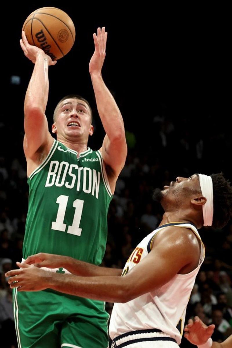 Boston Celtics' guard #11 Payton Pritchard jumps to shoot during the NBA Preseason game between the Boston Celtics and the Denver Nuggets at the Etihad Arena in Abu Dhabi on October 6, 2024.  Fadel Senna / AFP