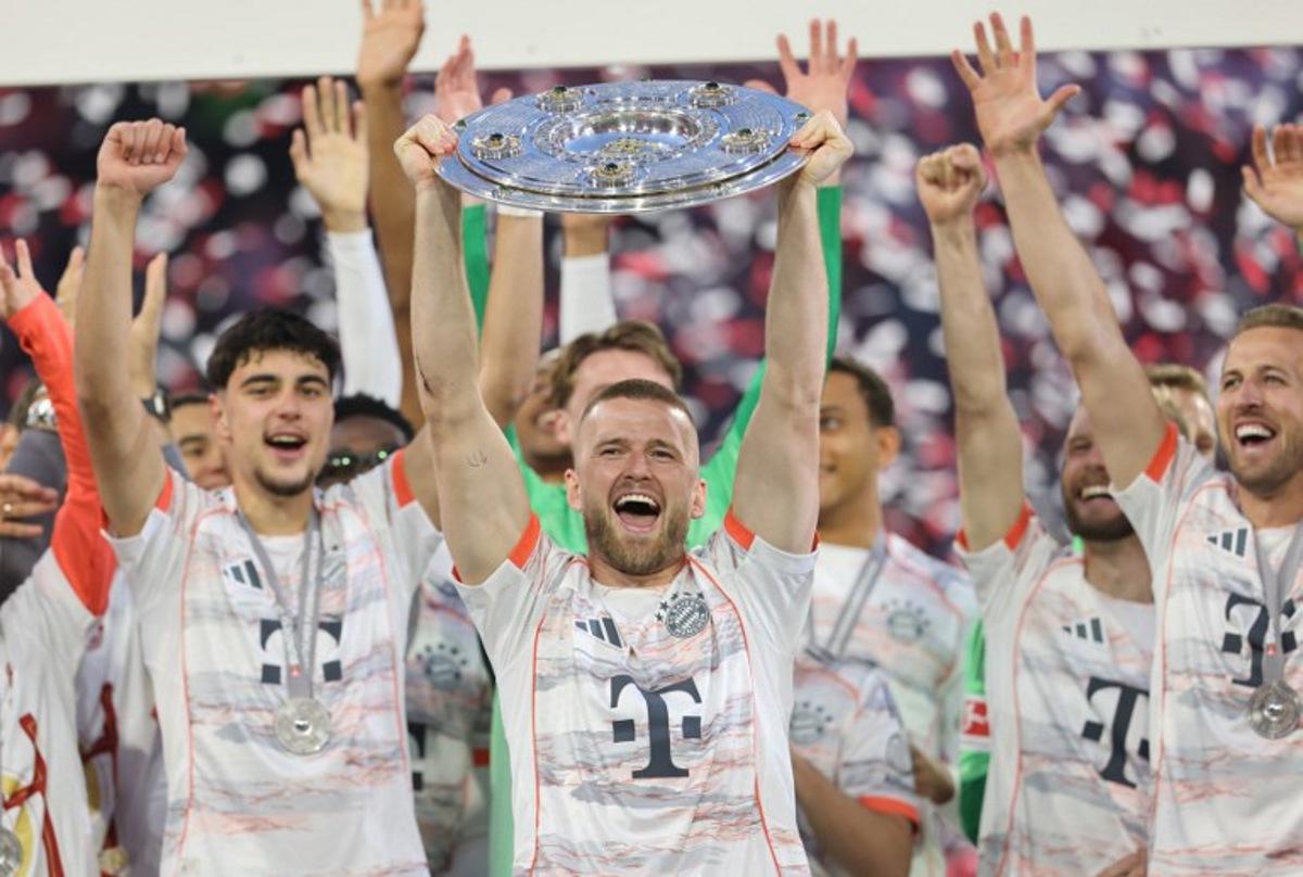 Bayern Munich's English defender #15 Eric Dier lifts the trophy after the German first division Bundesliga football match between Bayern Munich and Borussia Moenchengladbach in Munich on May 10, 2025.  Alexandra BEIER / AFP