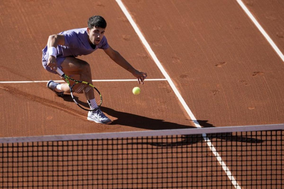 Spain's Carlos Alcaraz returns a shot to Denmark's Holger Rune during the ATP Barcelona Open "Conde de Godo" tennis tournament singles final match at the Real Club de Tenis in Barcelona, on April 20, 2025.  MANAURE QUINTERO / AFP