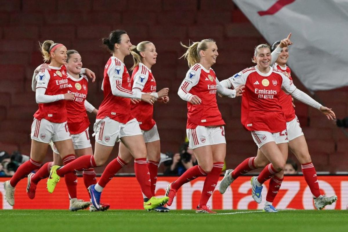 Teammates celebrate after Arsenal's Swedish striker #25 Stina Blackstenius scored the team's first goal during the UEFA Women's Champions League quarter-final 1st leg football match between Arsenal and Chelsea at The Emirates Stadium in London on March 24, 2026.  Glyn KIRK / AFP
