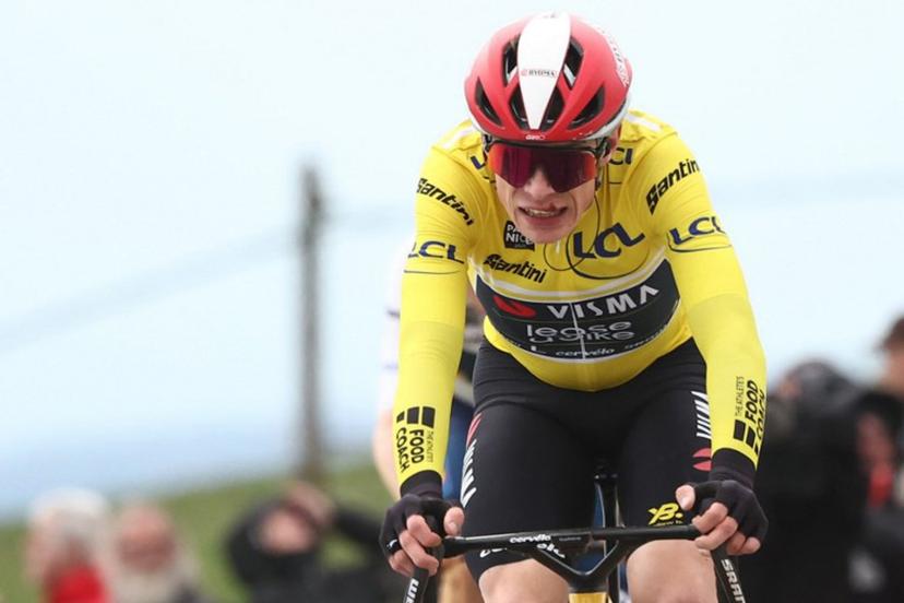 (FILES) Team Visma-Lease a Bike's Danish rider Jonas Vingegaard wearing the overall leader's yellow jersey reacts as he crosses the finish line of the 5th stage of the Paris-Nice cycling race, 203,3 km between Saint-Just-en-Chevalet and La Côte-Saint-André, on March 13, 2025. Two-time Tour de France winner Jonas Vingegaard withdrew from the Paris-Nice race before the start of the sixth stage on March 14, 2025, after injuring his hand in a fall. The Visma-Lease a Bike team said that its medical team had decided it was better that the Danish rider recovers at home and focus on upcoming goals. Anne-Christine POUJOULAT / AFP