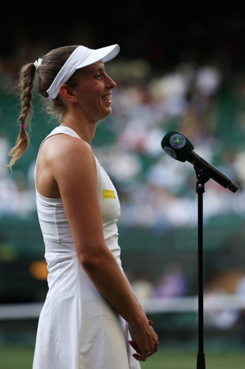 Belgium's Elise Mertens speaks to the audience after her victory over Ukraine's Elina Svitolina at the end of their women's singles third round tennis match on the fifth day of the 2025 Wimbledon Championships at The All England Lawn Tennis and Croquet Club in Wimbledon, southwest London, on July 4, 2025.  Adrian Dennis / AFP