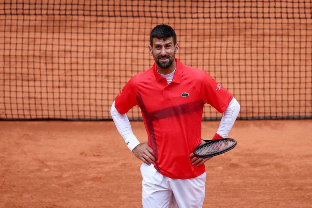 Serbia's Novak Djokovic reacts after asking to close the ceiling following a light rain during his men's singles match against US Mackenzie Mcdonald on day 3 of the French Open tennis tournament on Court Philippe-Chatrier at the Roland-Garros Complex in Paris on May 27, 2025.  FRANCK FIFE / AFP