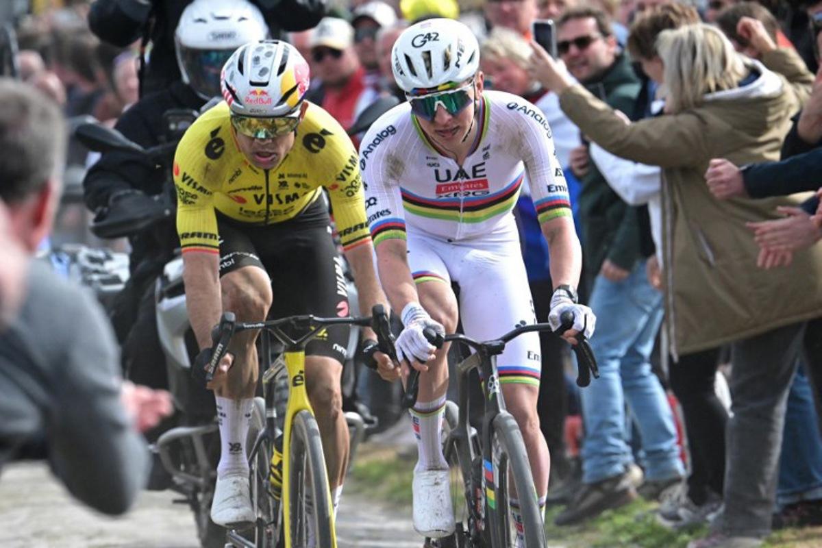 UAE Team Emirates XRG's Slovenian rider Tadej Pogacar cycles in a breakaway on a cobblestone sector ahead of Team Visma - Lease a Bike's Belgian rider Wout van Aert during the 123rd edition of the Paris-Roubaix one-day classic cycling race, 258.3 km between Compiègne and Roubaix, northern France, on April 12, 2026.   Bernard PAPON / POOL / AFP