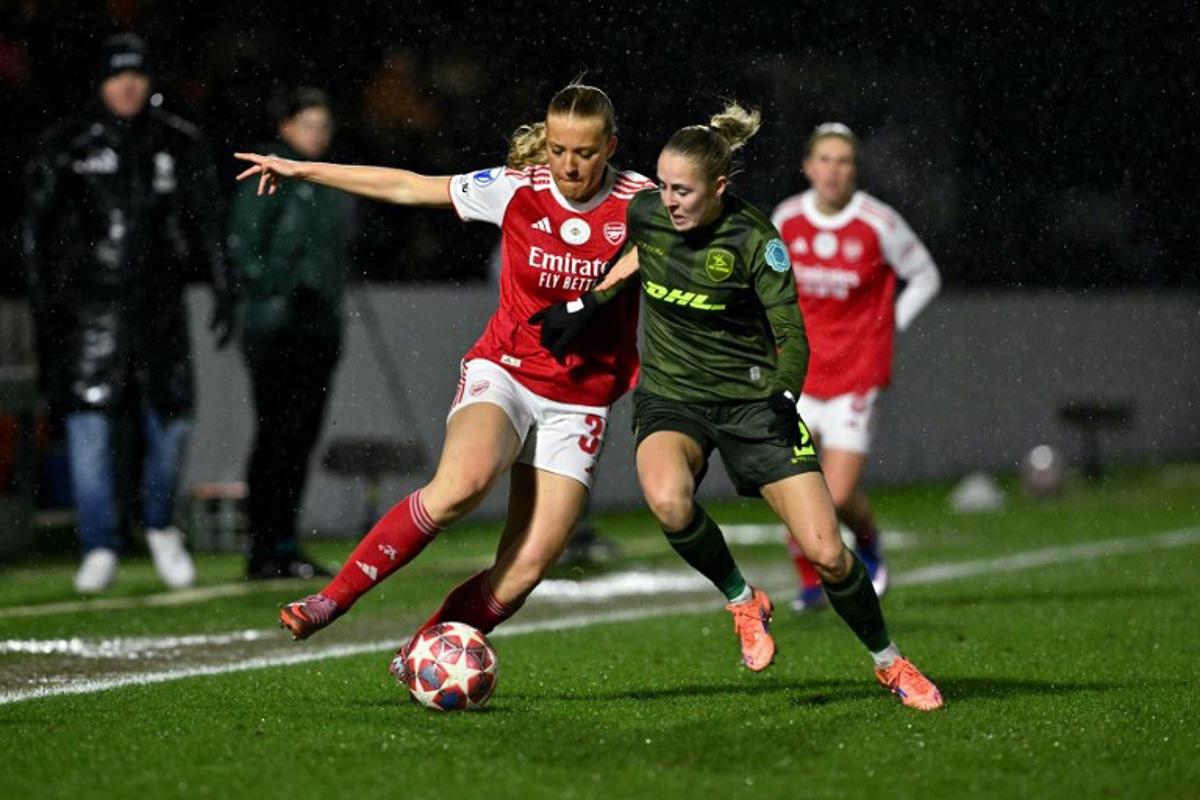 Arsenal's Swedish defender #31 Smilla Holmberg  battles for the ball with from OH Leuven's Belgian defender #02 Saar Janssen during the UEFA Women's Champions League knockout stage football match between Arsenal and Oud-Heverlee Leuven at Meadow Park in Borehamwood, north of London on February 18, 2026.  Glyn KIRK / AFP