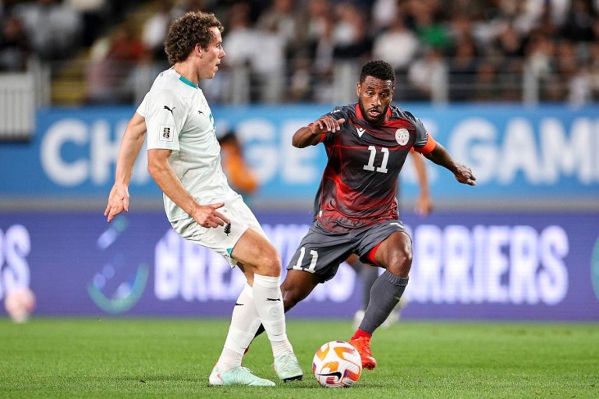 New Caledonia's Cesar Zeoula (R) challenges New Zealand's Joe Bell during the FIFA World Cup 2026 Oceania qualifiers group final football match between New Zealand and New Caledonia at Eden Park Stadium in Auckland on March 24, 2025.  DAVID ROWLAND / AFP