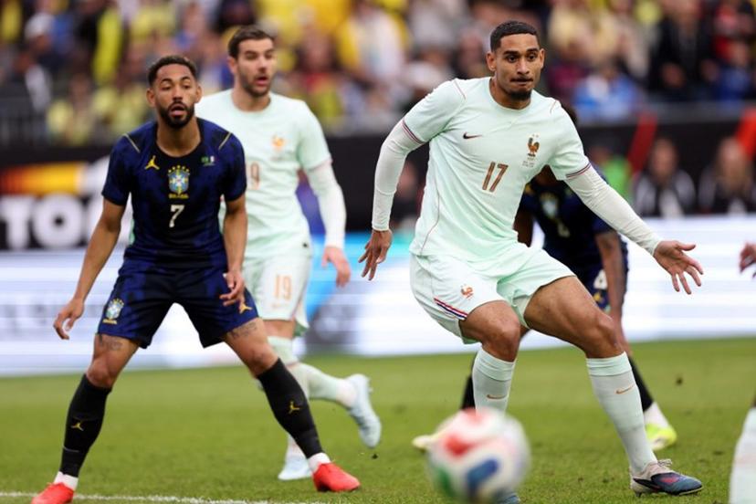 France's defender #17 Maxence Lacroix and Brazil's forward #07 Matheus Cunha look on during a friendly football match between Brazil and France at Gillette Stadium in Foxborough, Massachusetts, on March 26, 2026.  FRANCK FIFE / AFP