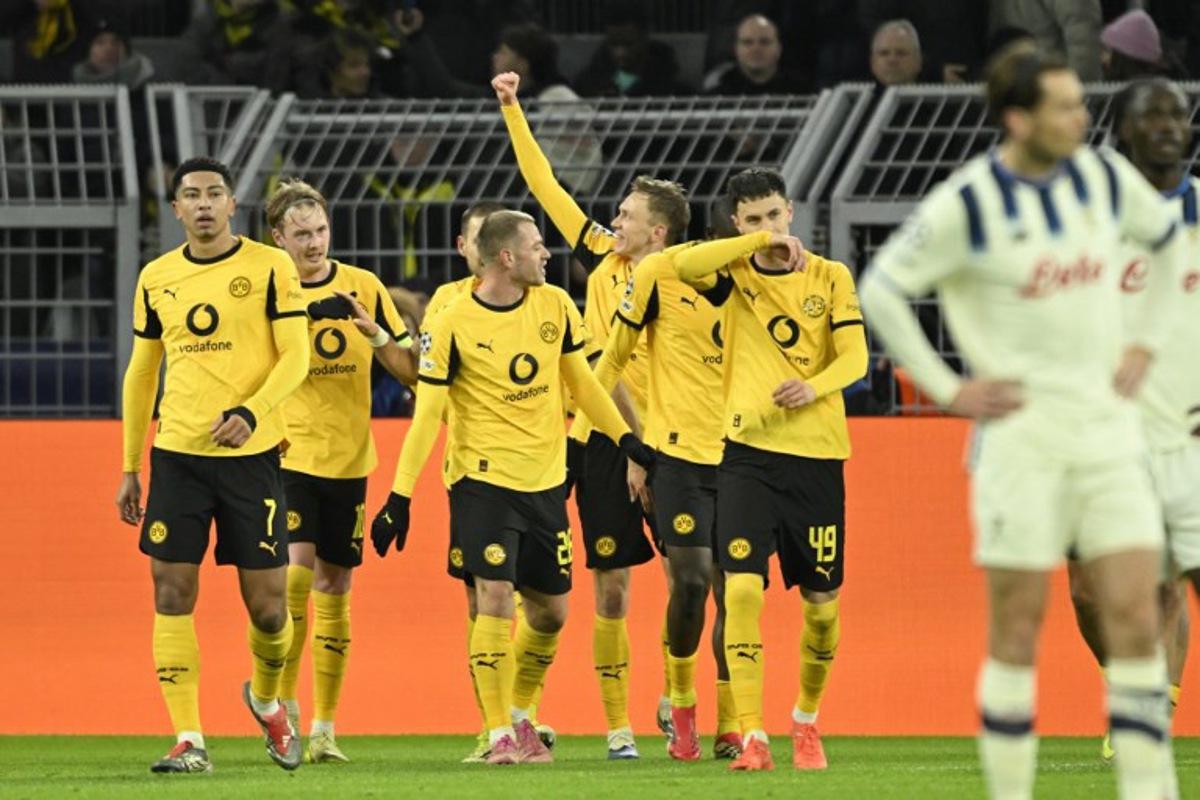Dortmund's German forward #14 Maximilian Beier celebrates scoring his team's second goal 2:0 with his team mates during the UEFA Champions League knockout round play-off first Leg football match between BVB Borussia Dortmund and Atalanta Bergamo in Dortmund, western Germany, on February 17, 2026.   INA FASSBENDER / AFP
