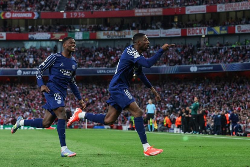 Paris Saint-Germain's French forward #10 Ousmane Dembele (R) celebrates after scoring his team first goal during the UEFA Champions League Semi-final First Leg football match between Arsenal and Paris Saint-Germain (PSG) at the Emirates Stadium in north London, on April 29, 2025.  Adrian Dennis / AFP