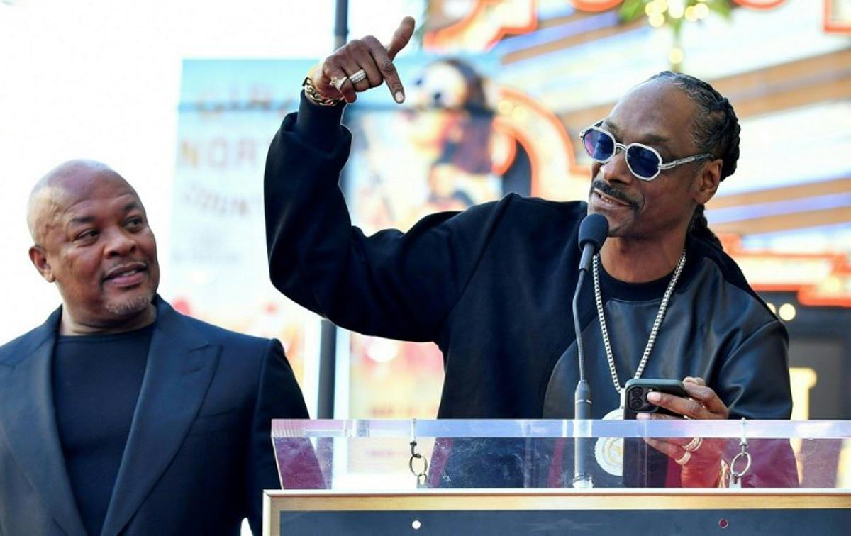 US rapper Dr. Dre (L) listens to US rapper Snoop Dog speak at his Hollywood Walk of Fame ceremony in Hollywood, California, on March 19, 2024.  VALERIE MACON / AFP