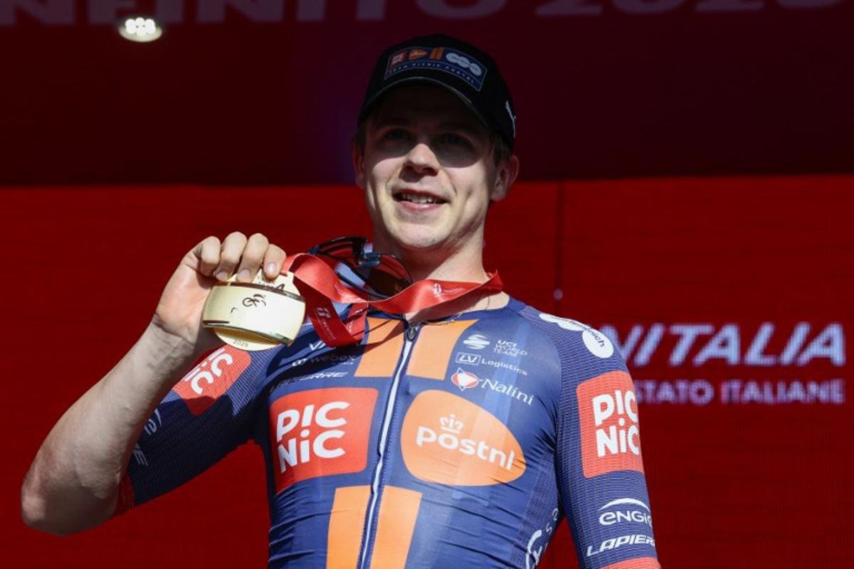 Team Picnic PostNL's Dutch rider Casper Van Uden poses for pictures on the podium after winning the 4th stage of the 108th Giro d'Italia cycling race 189kms from Alberobello to Lecce on May 13, 2025.  Luca Bettini / AFP