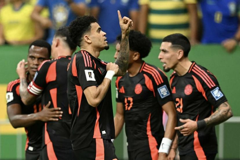 Colombia's forward #07 Luis Diaz (C) celebrates with teammates after scoring during the 2026 FIFA World Cup South American qualifiers football match between Brazil and Colombia, at the Mane Garrincha stadium in Brasilia, on March 20, 2025.  EVARISTO SA / AFP