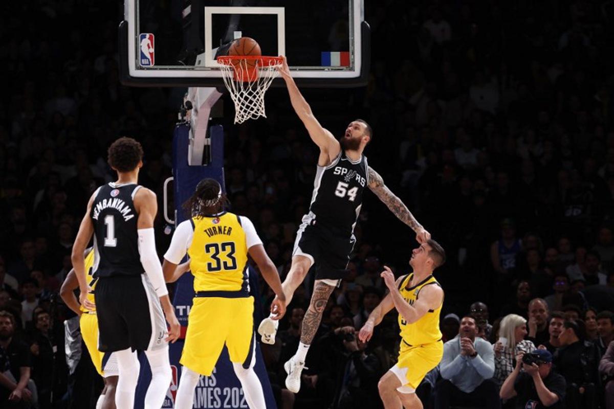 San Antonio Spurs' Georgian-US forward-center #54 Sandro Mamukelashvili (C) jumps to the net  during the NBA basketball game between the San Antonio Spurs and the Indiana Pacers at the Accor Arena - Palais Omnisports de Paris-Bercy - in Paris on January 25, 2025.  FRANCK FIFE / AFP