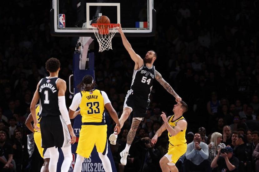 San Antonio Spurs' Georgian-US forward-center #54 Sandro Mamukelashvili (C) jumps to the net  during the NBA basketball game between the San Antonio Spurs and the Indiana Pacers at the Accor Arena - Palais Omnisports de Paris-Bercy - in Paris on January 25, 2025.  FRANCK FIFE / AFP