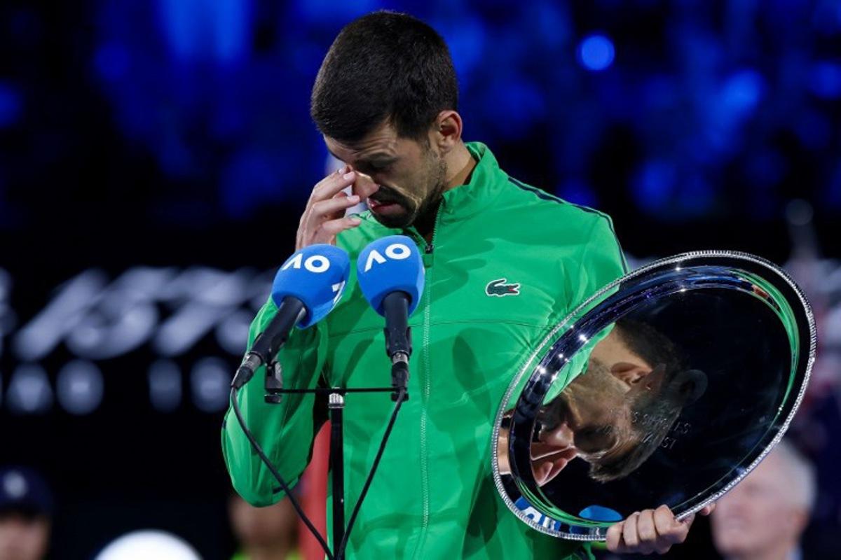 Serbia's Novak Djokovic speaks after receiving the runner-up shield following his defeat to Spain's Carlos Alcaraz in the men's singles final on Day 15 of the Australian Open. tennis tournament in Melbourne on February 1, 2026.  IZHAR KHAN / AFP