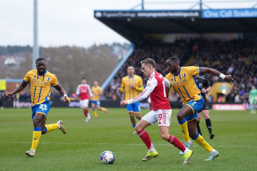 Arsenal's Belgian midfielder #19 Leandro Trossard (C) takes on the Mansfield defence during the English FA Cup fifth round football match between Mansfield Town and Arsenal at the One Call Stadium, Field Mill in Mansfield, central England on March 7, 2026.  Jon Super / AFP