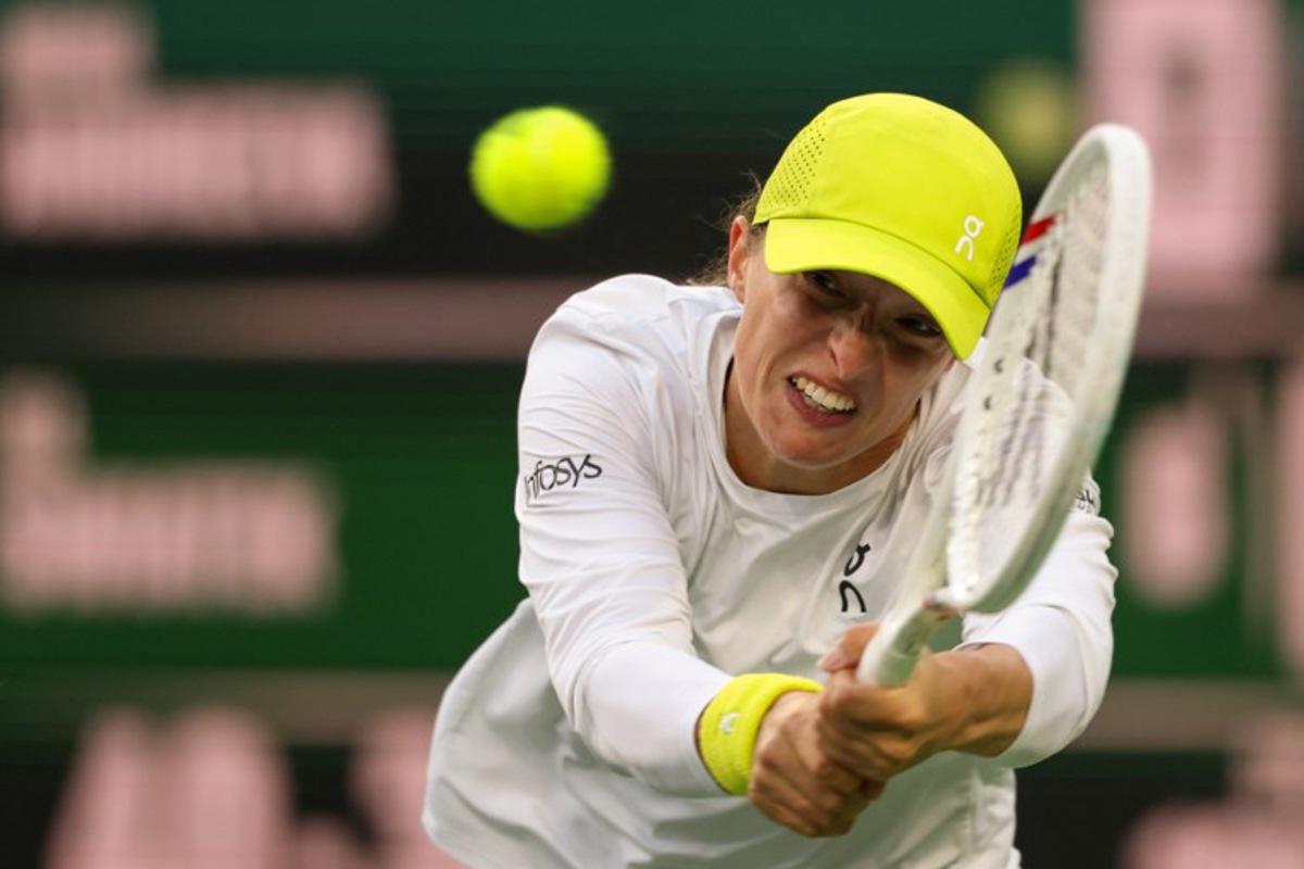 Poland's Iga Swiatek returns the ball to Russia's Mirra Andreeva during a women's singles semi-final tennis match at the BNP Paribas Open at the Indian Wells Tennis Garden in Indian Wells, California, on March 14, 2025.  Patrick T. Fallon / AFP