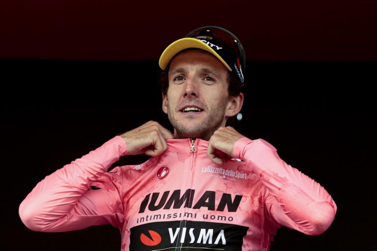 Team Visma-Lease a Bike's British rider Simon Yates celebrates on the podium after winning the pink jersey of overall leader (Maglia Rosa) in the 20th stage of the 108th Giro d'Italia cycling race 205kms from Verres to Sestriere on May 31, 2025.  Luca Bettini / AFP