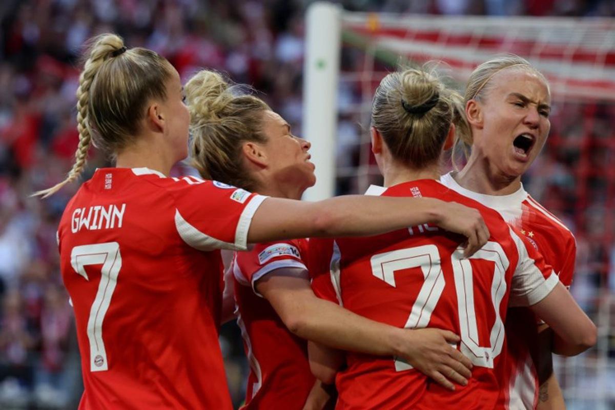Bayern Munich's German forward #20 Franziska Kett (2nd R) celebrates scoring the 1-1 goal with her teammates during the UEFA Women's Champions League semi-final first leg football match between FC Bayern Munich and FC Barcelona in Munich, southern Germany on April 25, 2026.  Karl-Josef HILDENBRAND / AFP