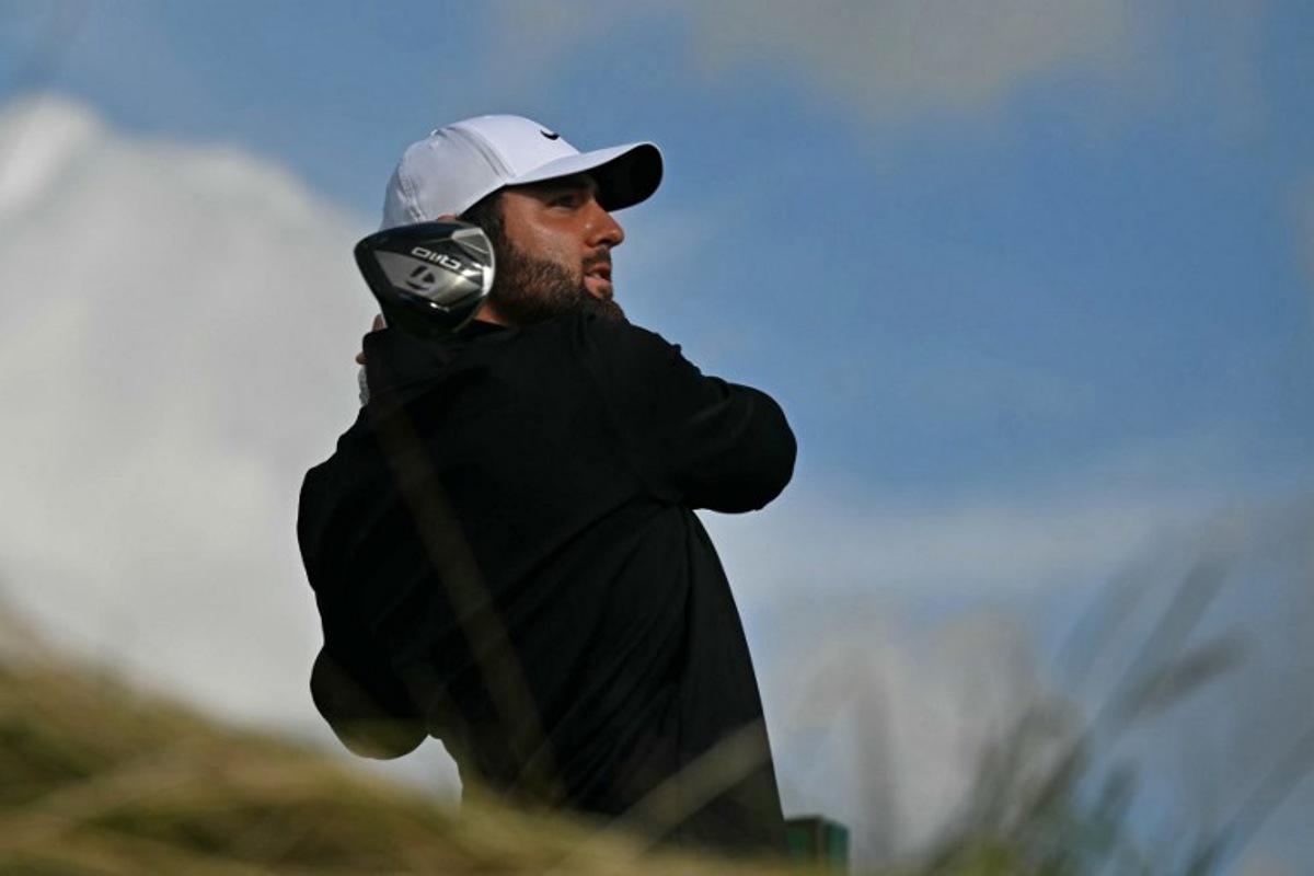 US golfer Scottie Scheffler watches his drive from the 12th tee on day three of the 153rd Open Championship at Royal Portrush golf club in Northern Ireland on July 19, 2025.  Glyn KIRK / AFP