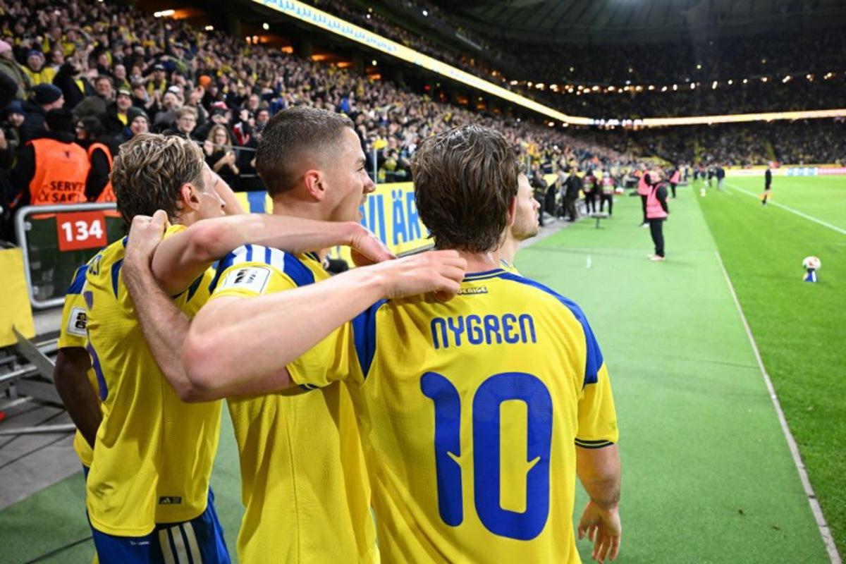 Sweden's defender #02 Gustaf Lagerbielke celebrates scoring his team's second goal 2:1 with his team mates during the FIFA World Cup 2026 European qualification final football match between Sweden and Poland in Solna, Sweden, on March 31, 2026.  Jonathan Nackstrand / AFP