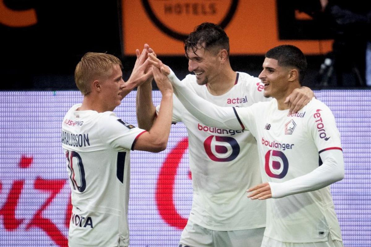 Lille's spanish forward #07 Matias Fernandez Pardo (R) celebrates with teammates after scoring his team's second goal during the French L1 football match between FC Lorient and lille OSC at Yves-Allainmat stadium in Lorient, western France on August 30, 2025.   Loic VENANCE / AFP