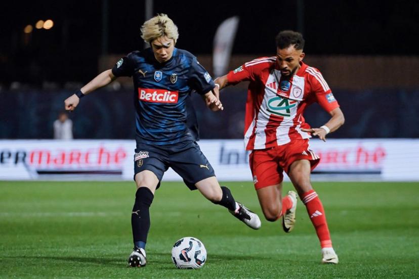 Reims' Japanese forward #07 Junya Ito (L) fights for the ball with AS Cannes' Mauritanian defender #27 Houssen Abderrahmane during the French Cup (Coupe de France) semi-final football match between AS Cannes and Stade de Reims at Pierre-de-Coubertin stadium in Cannes, southeastern France, on April 2, 2025.  Frederic DIDES / AFP