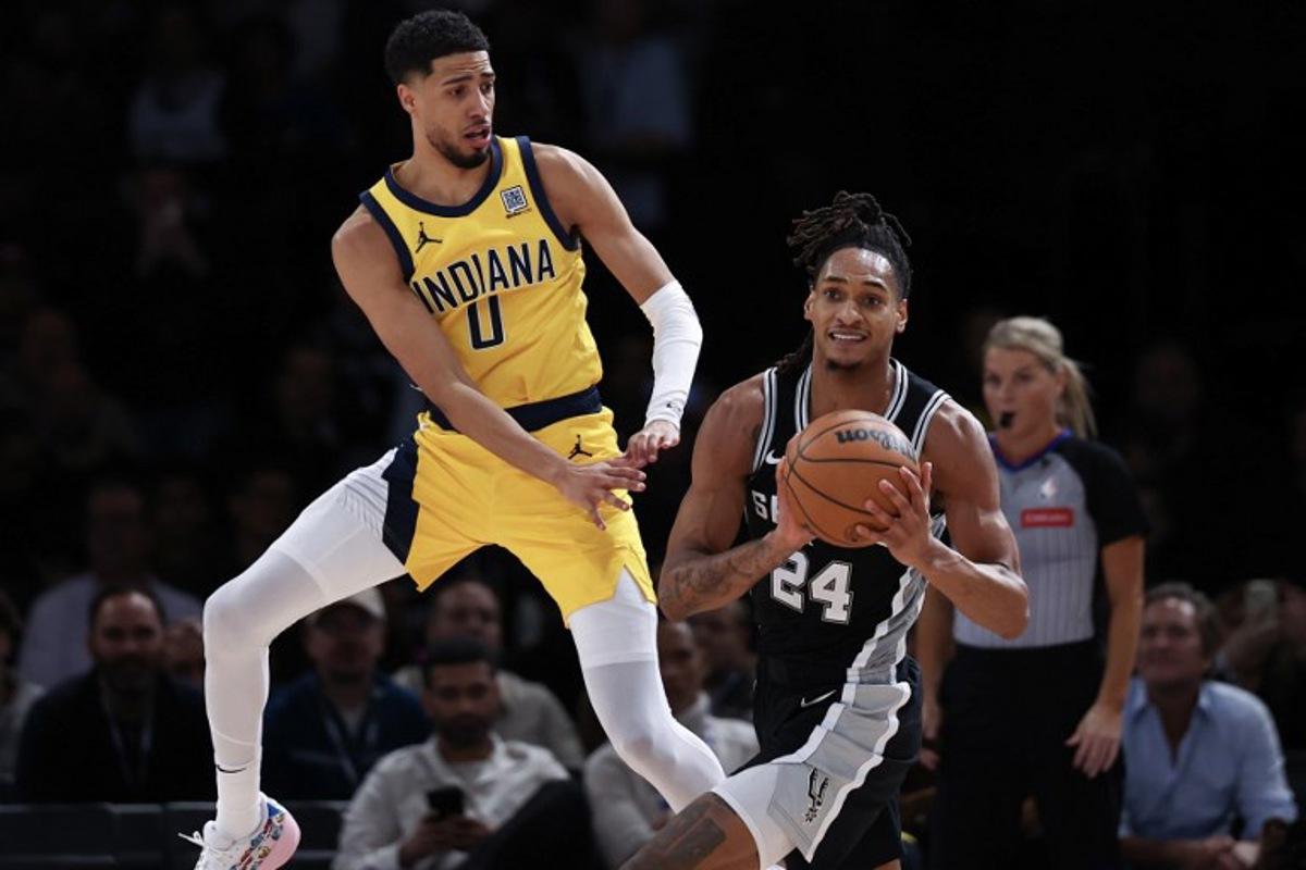 Indian Pacer's US Guard #0 Tyrese Haliburton (L) vies for the ball with San Antonio Spurs' US guard-forward #24 Devin Vassell (R) during the NBA basketball game between the Indiana Pacers and the San Antonio Spurs at the Accor Arena - Palais Omnisports de Paris-Bercy - in Paris on January 23, 2025.  FRANCK FIFE / AFP